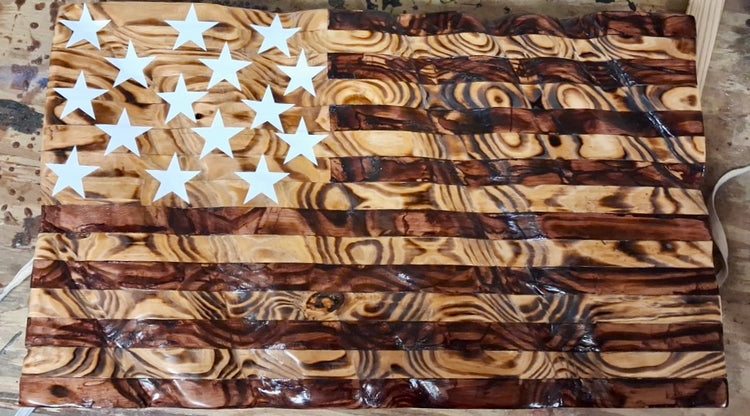 Wooden Ft. McHenry flag with white stars, dark stripes and prominent wood grain.
