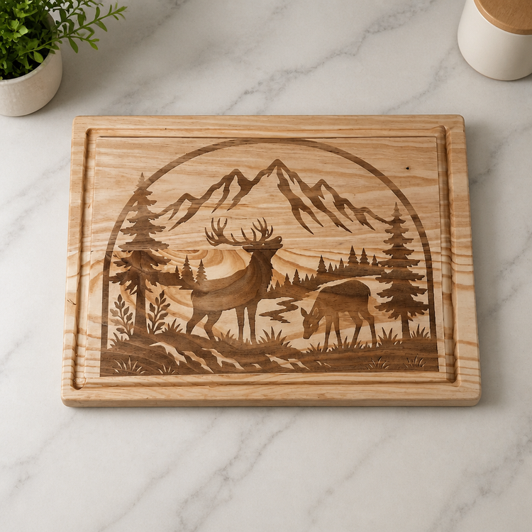 Wood serving board engraved with elk, mountains, pine trees and a winding river.
